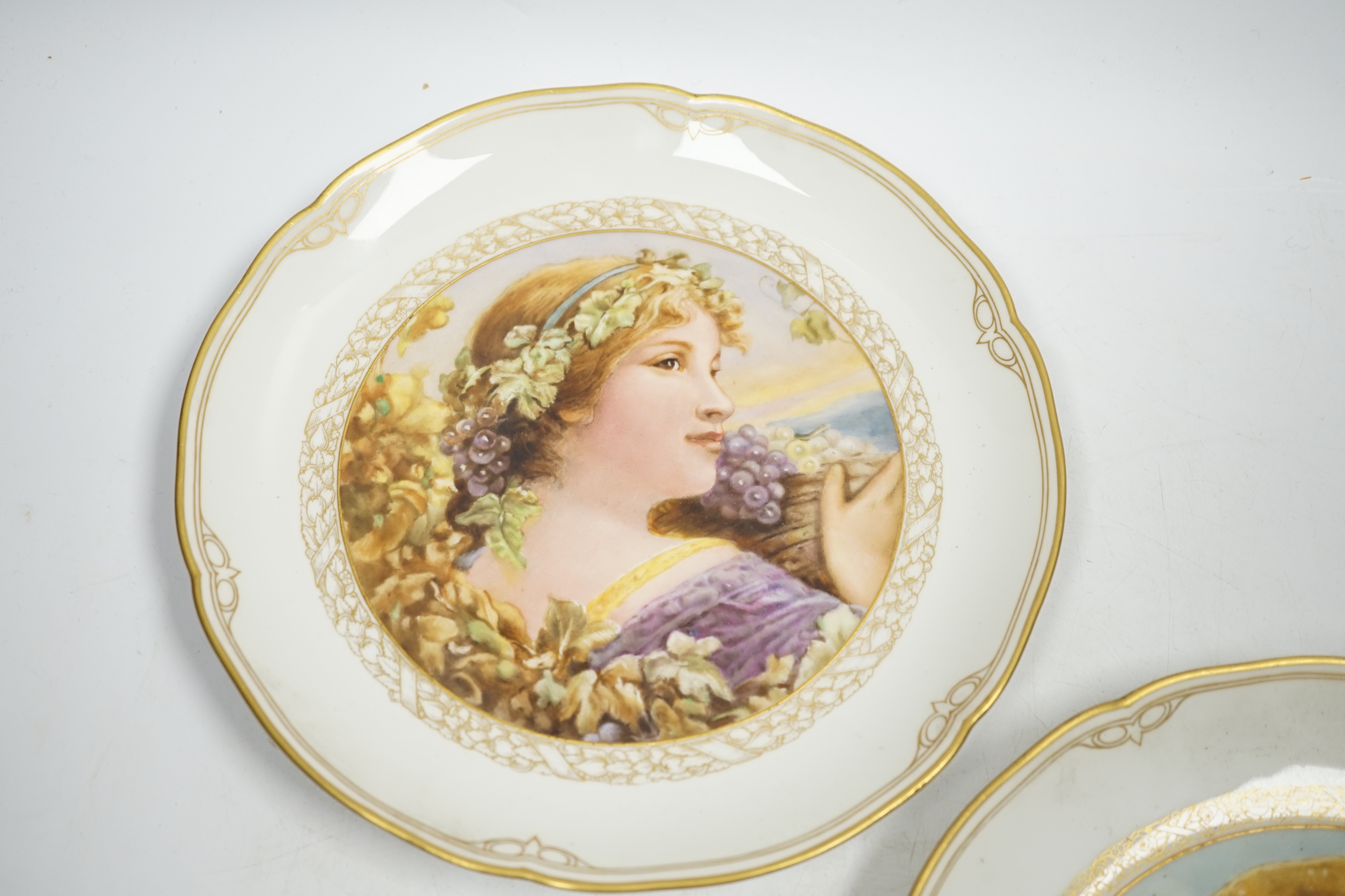A pair of late 19th century Berlin plates, hand painted with females, 21.5cm